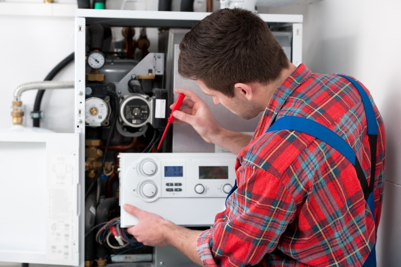 Gas Safe engineer working on a boiler in Chingford